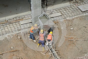 Group of construction workers casting for ground beam