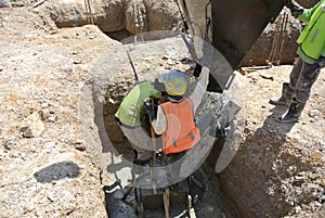 Group of construction workers casting pile cap