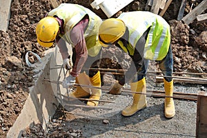 Group of construction workers fabricating ground beam steel reinforcement bar