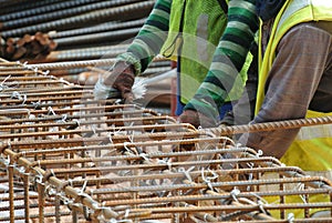 Group of construction workers fabricating pile cap steel reinforcement bar