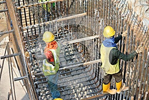 Group of construction workers fabricating pile cap steel reinforcement bar