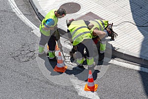 Group of construction Workers repairing an asphalt road on city
