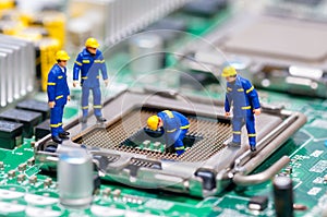 Group of construction workers repairing CPU photo