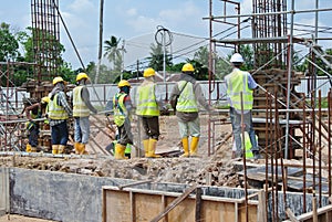 Group of construction workers standing at the construction site.