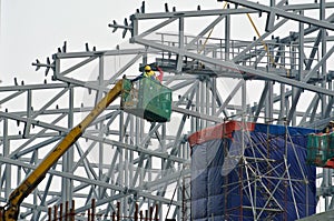 Group of construction workers standing in the mobile crane basket