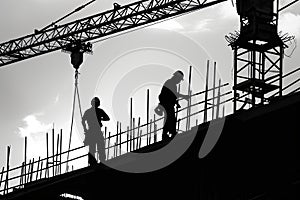 a group of construction workers working on a building, a group of construction work