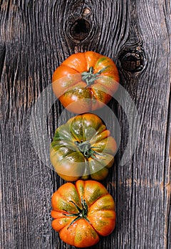 A group of Costoluto tomatos on a wooden background