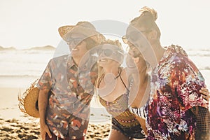 Group of couples friends have fun together at the beach in summer holiday vacation - people and travel activity lifestyle - young