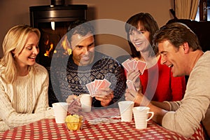 Group Of Couples Playing Cards Together