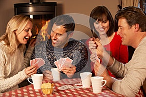 Group Of Couples Playing Cards Together