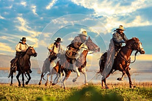 A group of cowboys riding horses. photo