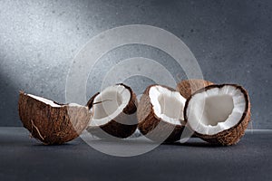 Group of cracked coconut fruit and whole coconut