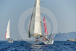 Group of cruising sailboats is sailing in the Mediterranean sea.