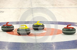 Group of curling rocks on ice