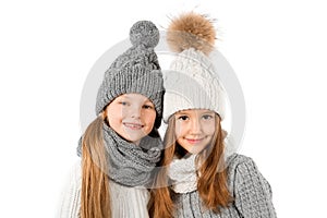 Group of cute kids in winter warm hats and scarfs on white. Children winter clothes