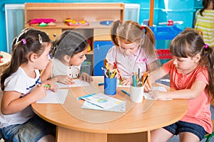 Group of cute little prescool kids drawing