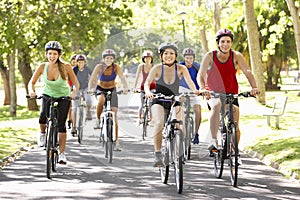 Group Of Cyclists On Cycle Ride Through Park