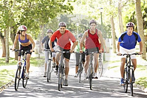 Group Of Cyclists On Cycle Ride Through Park