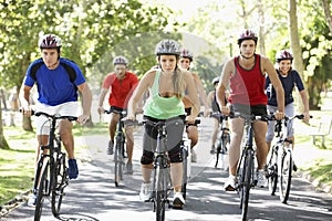 Group Of Cyclists On Cycle Ride Through Park