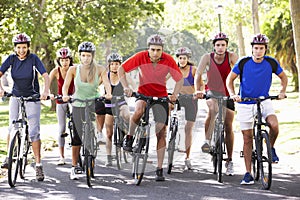 Group Of Cyclists On Cycle Ride Through Park