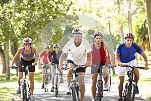 Group Of Cyclists On Cycle Ride Through Park
