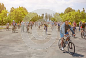 A group of cyclists organized a summer arrival on bikes on the road.