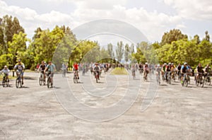 Group of cyclists organized a summer arrival on bikes on the road.