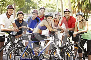 Group Of Cyclists Resting During Cycle Ride Through Park