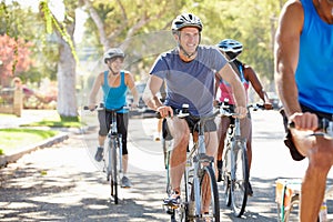 Group Of Cyclists On Suburban Street