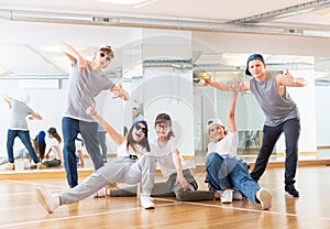 Group of dancing teenagers posing in dance studio