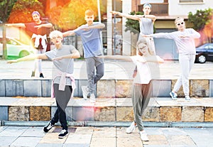 Group of dancing teenagers posing at street. Hip hop dancers