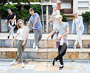 Group of dancing teenagers posing at street. Hip hop dancers