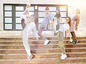 Group of dancing teenagers posing at street. Hip hop dancers