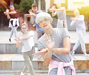 Group of dancing teenagers posing at street. Hip hop dancers