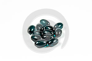 Group of dark green soft gelatine capsules.