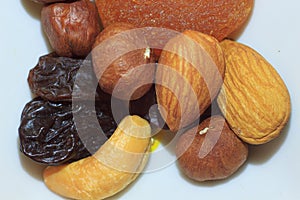 Group of delicious nuts, raisins and dried apricots.