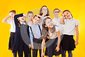 Group of demotivated schoolchildren are standing together