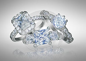 Group of Diamond wedding engagement RIngs set and on a gray background