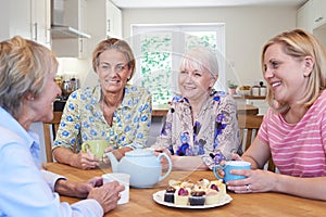 Group Of Different Aged Female Friends Meeting At Home