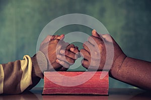Group of different men praying together,