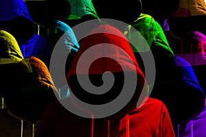 Group of differently colored hooded hackers cybersecurity concept