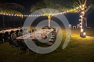 group dinner by beach with light decoration
