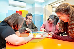 Group of disabled people playing board games together