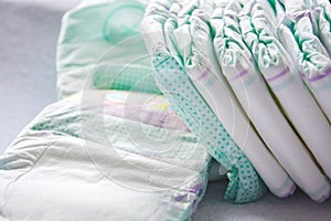 Group of disposable diapers arranged over a white changing table