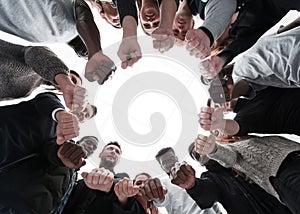 Group of diverse ambitious young people standing in a circle