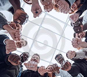group of diverse ambitious young people standing in a circle