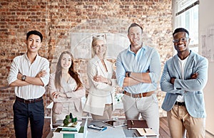 Group of diverse architects discussing plans, blueprints and schematics during a meeting in their office boardroom