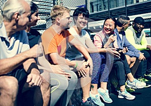 Group of diverse athletes sitting together at gym