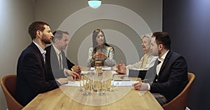 Group of diverse business partners gather in modern office boardroom