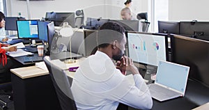 Group of diverse business people using computer and walking in office, slow motion